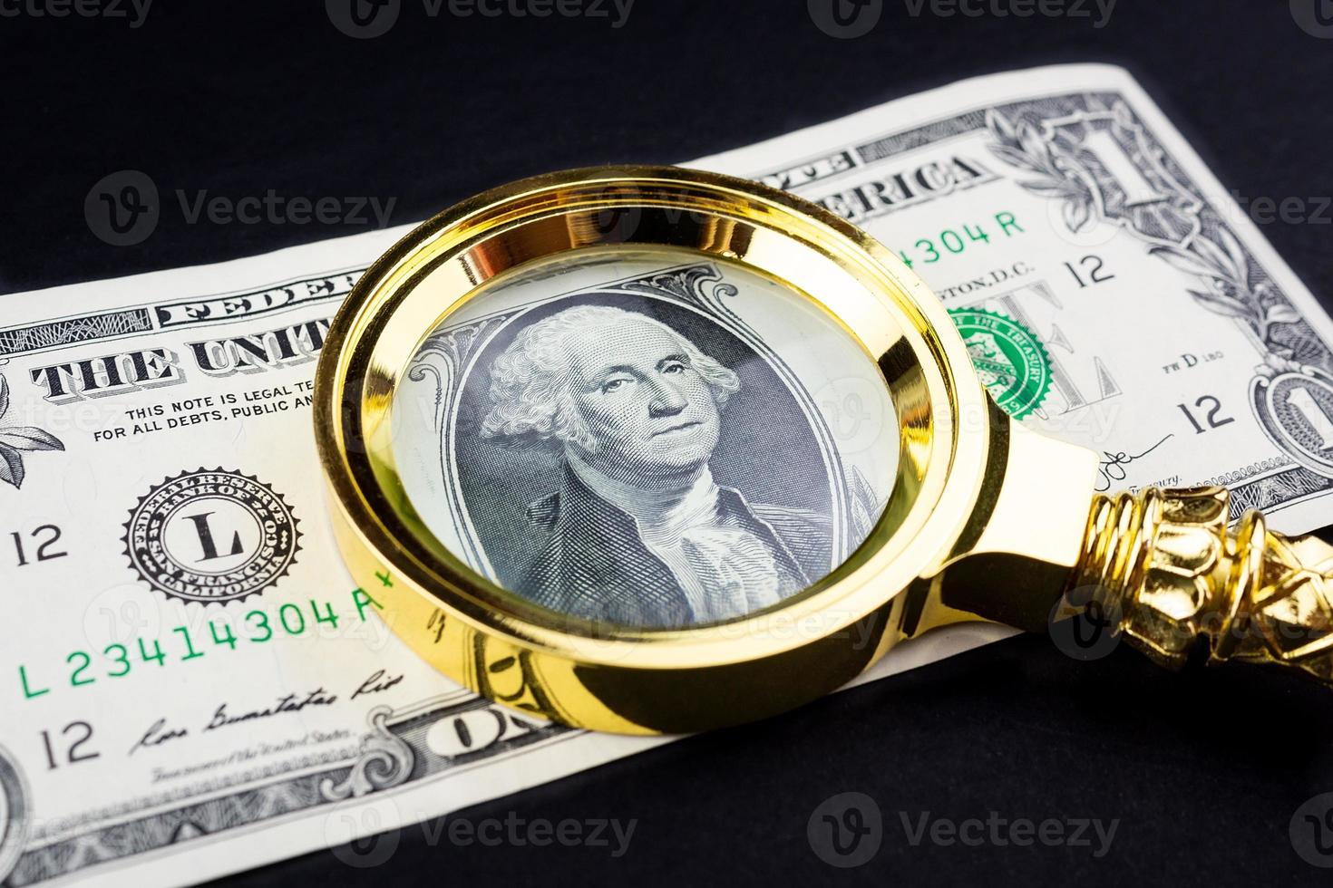 Dollar and a magnifying glass photo