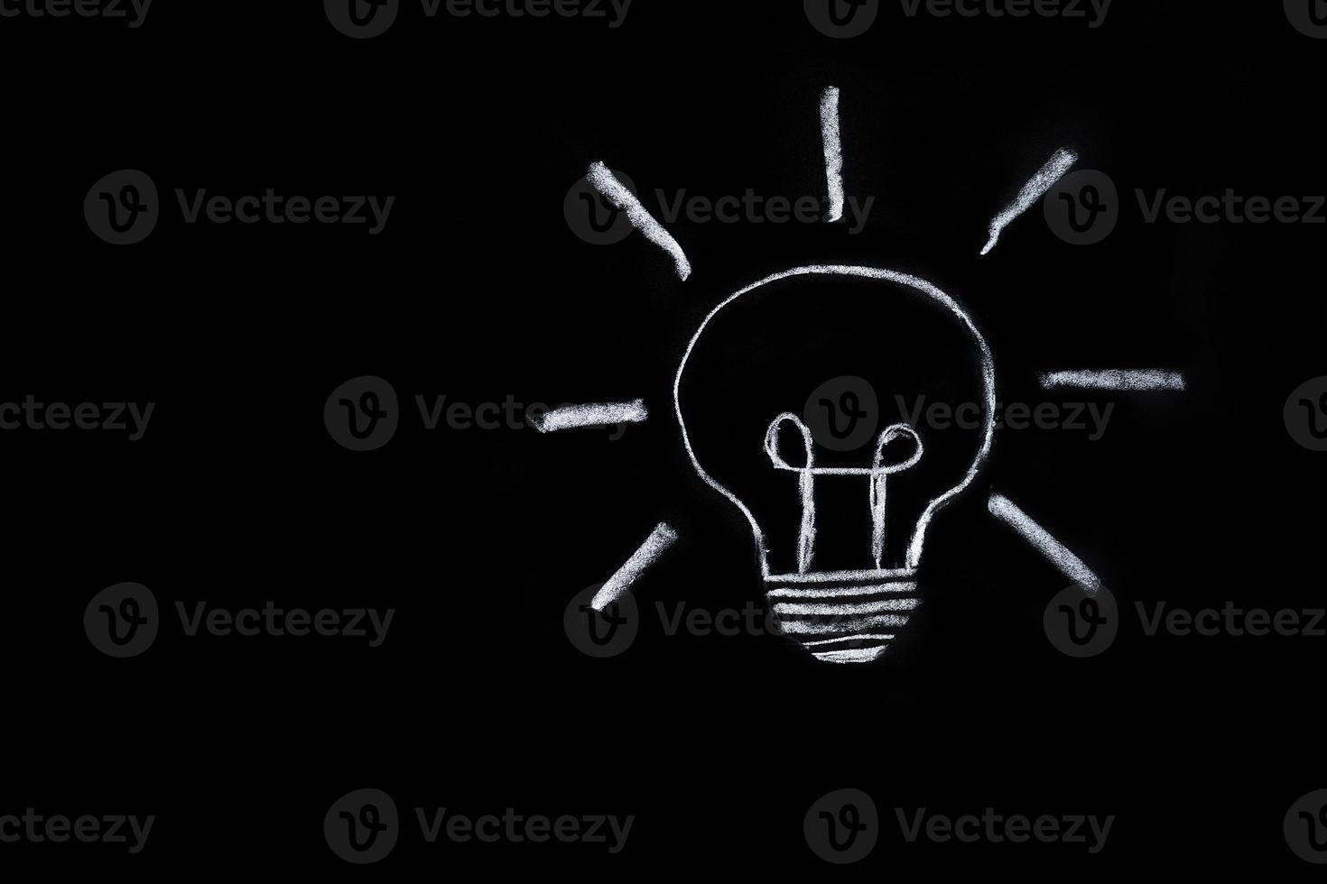 Light bulb on black background photo