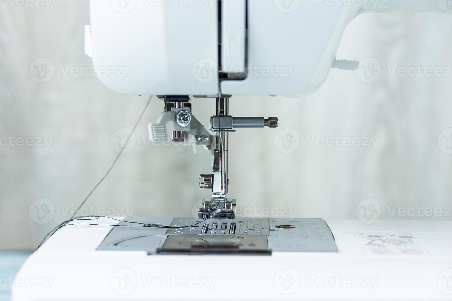 Hands on the sewing machine photo