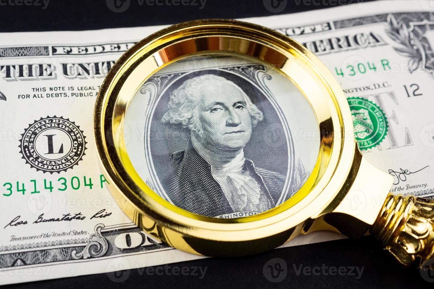 Dollar and a magnifying glass photo