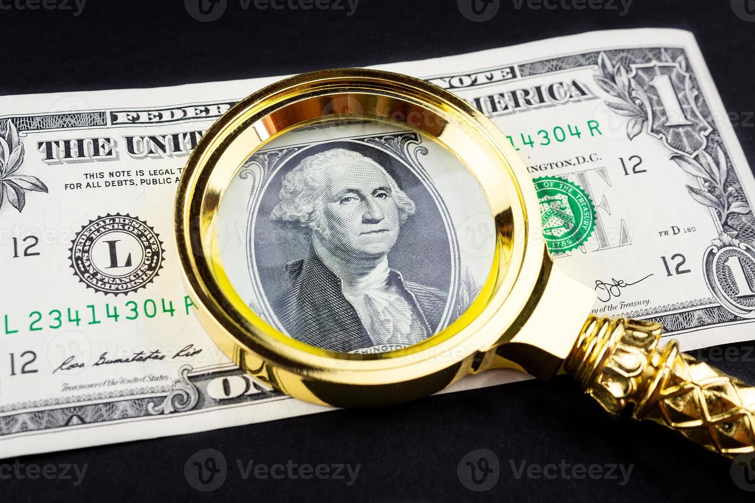 Dollar and a magnifying glass photo