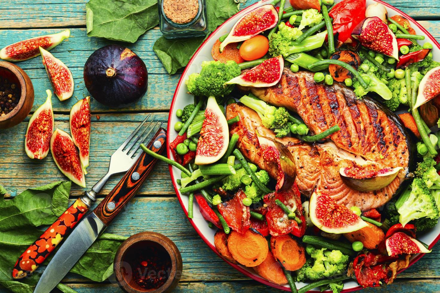 Trout steak fried with vegetables. photo