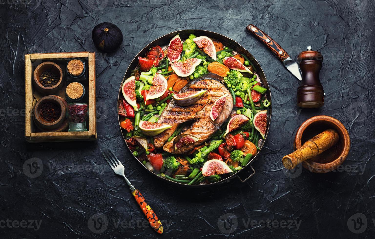 Trout steak fried with vegetables. photo