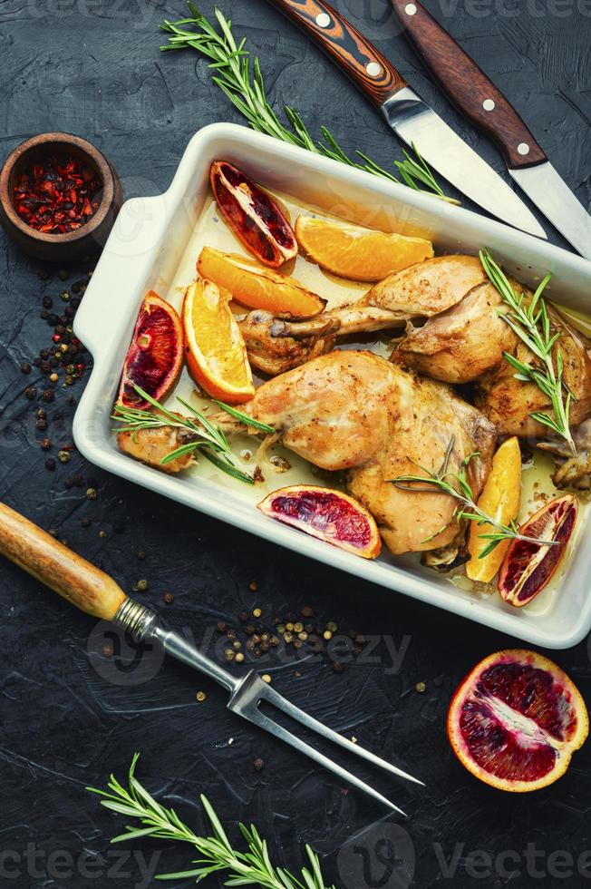 Baked chicken legs with oranges photo