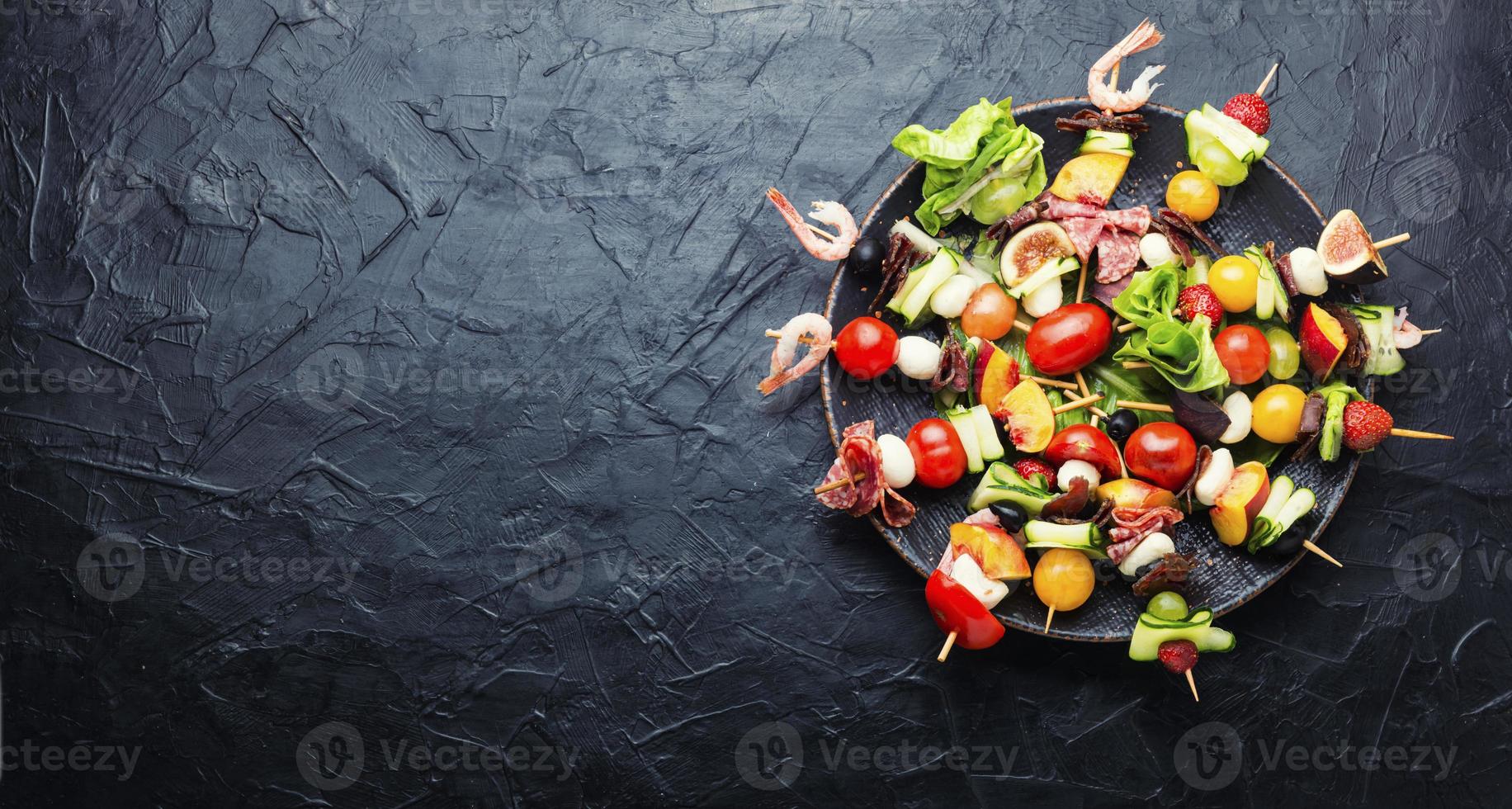 snack from vegetables, fruits, meat and seafood photo