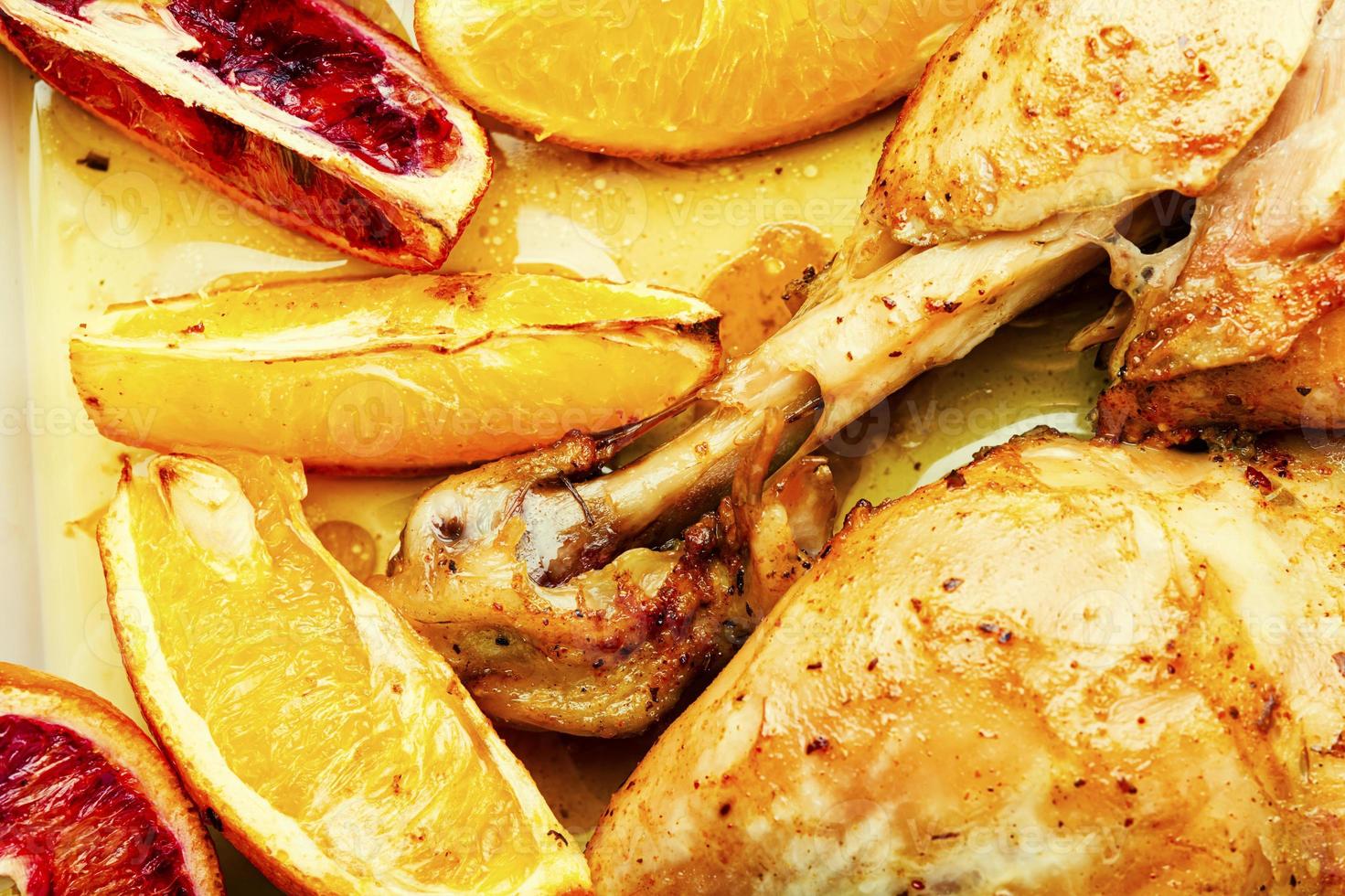 Roasted chicken legs with oranges photo