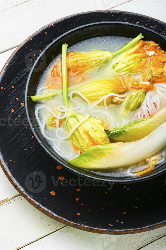 Rice noodle soup with pumpkin flowers photo