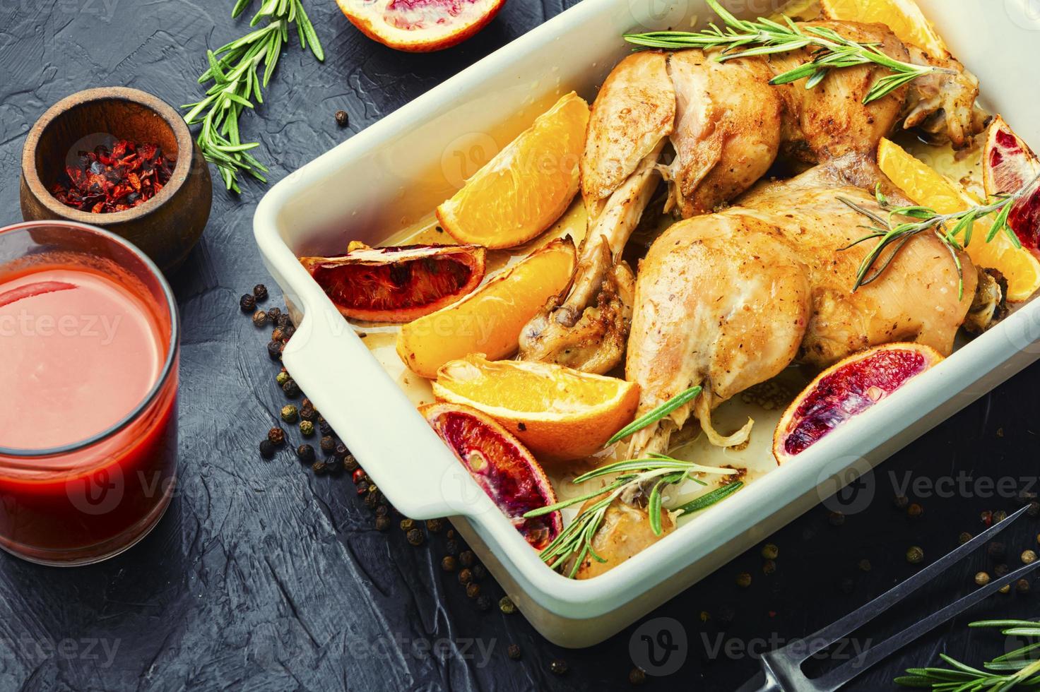 Roasted chicken legs with oranges photo