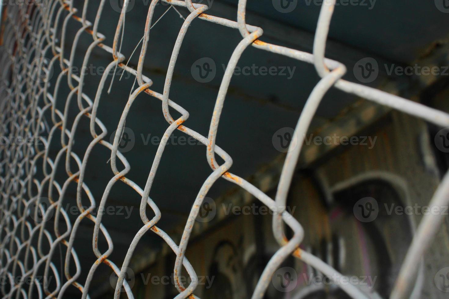 Rusty metal mesh close-up on the background of painted walls. photo