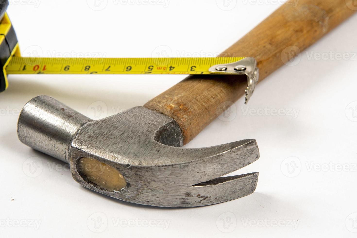 yellow tape measure and hammer photo
