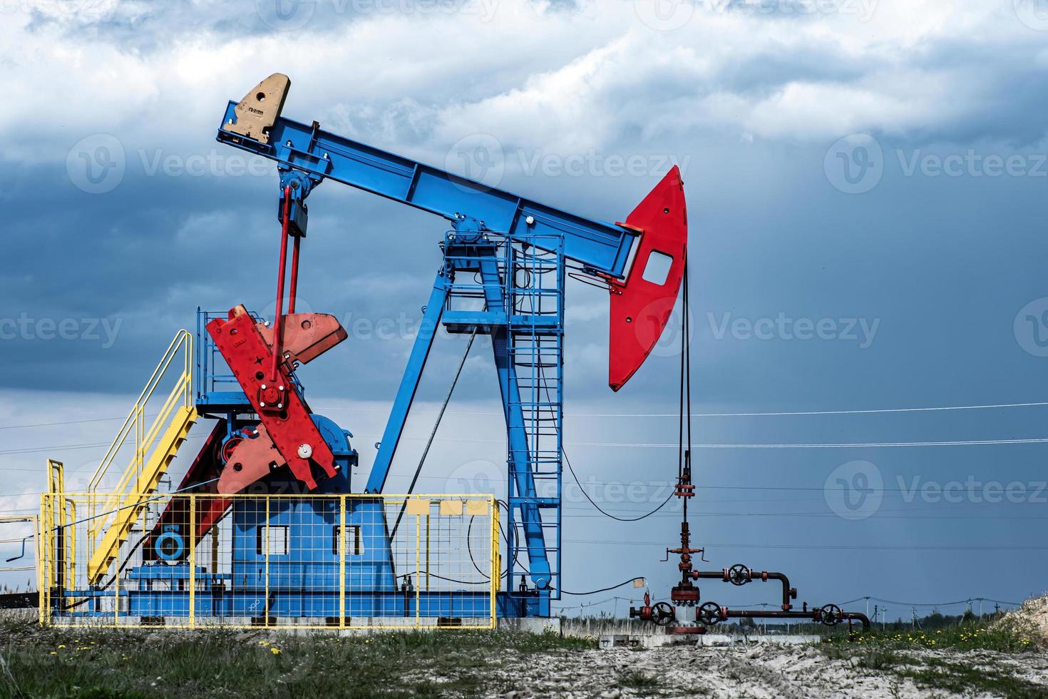 Extraction of crude oil in oilfield. Oil drilling rig pumps oil. photo
