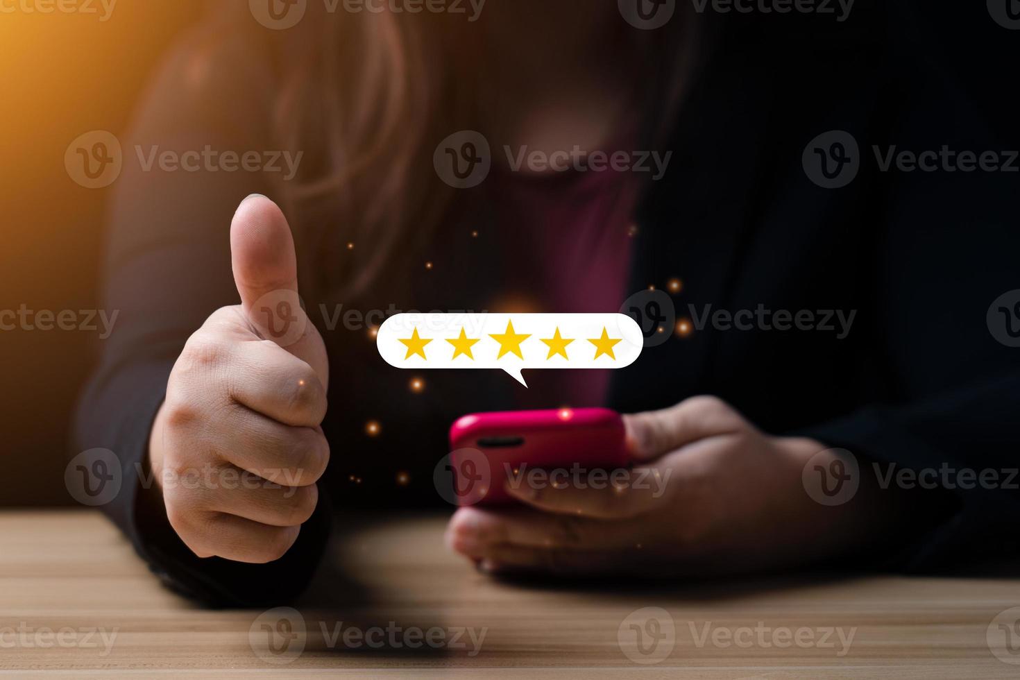 Customer satisfaction concept.hand of business woman using smartphone with five star pop-up icon for feedback. with copy space. 5 star satisfaction, Excellent business rating experience photo