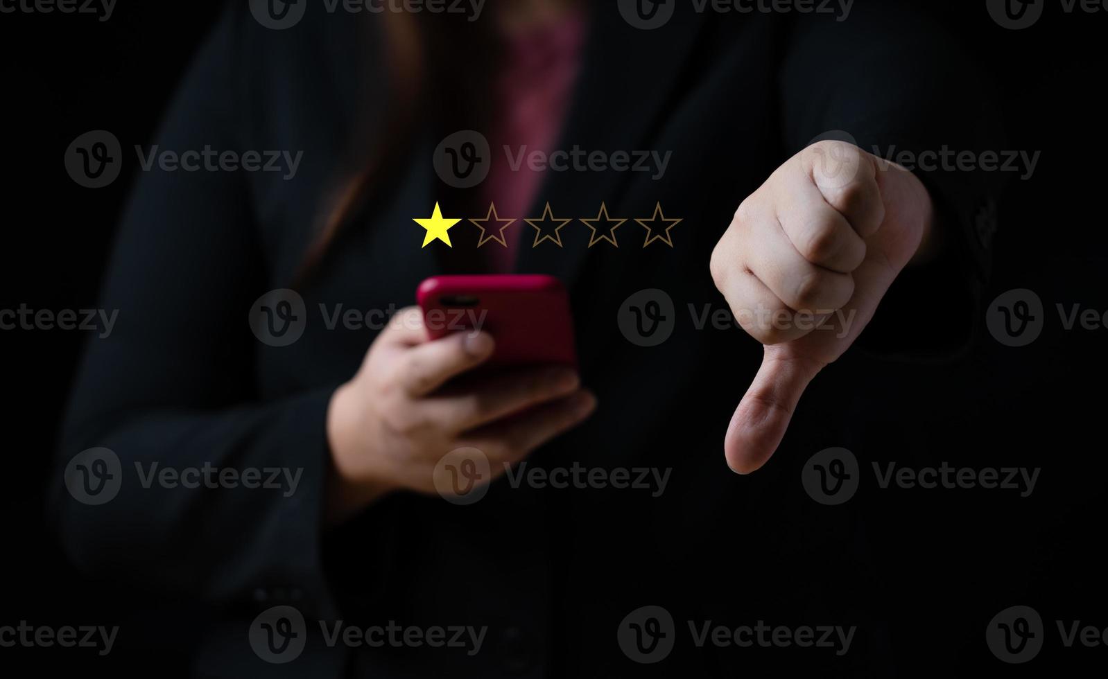 Business women select bad face emoticon on virtual touch screen at smartphone. Bad review, bad service dislike bad quality, low rating, social media not good photo