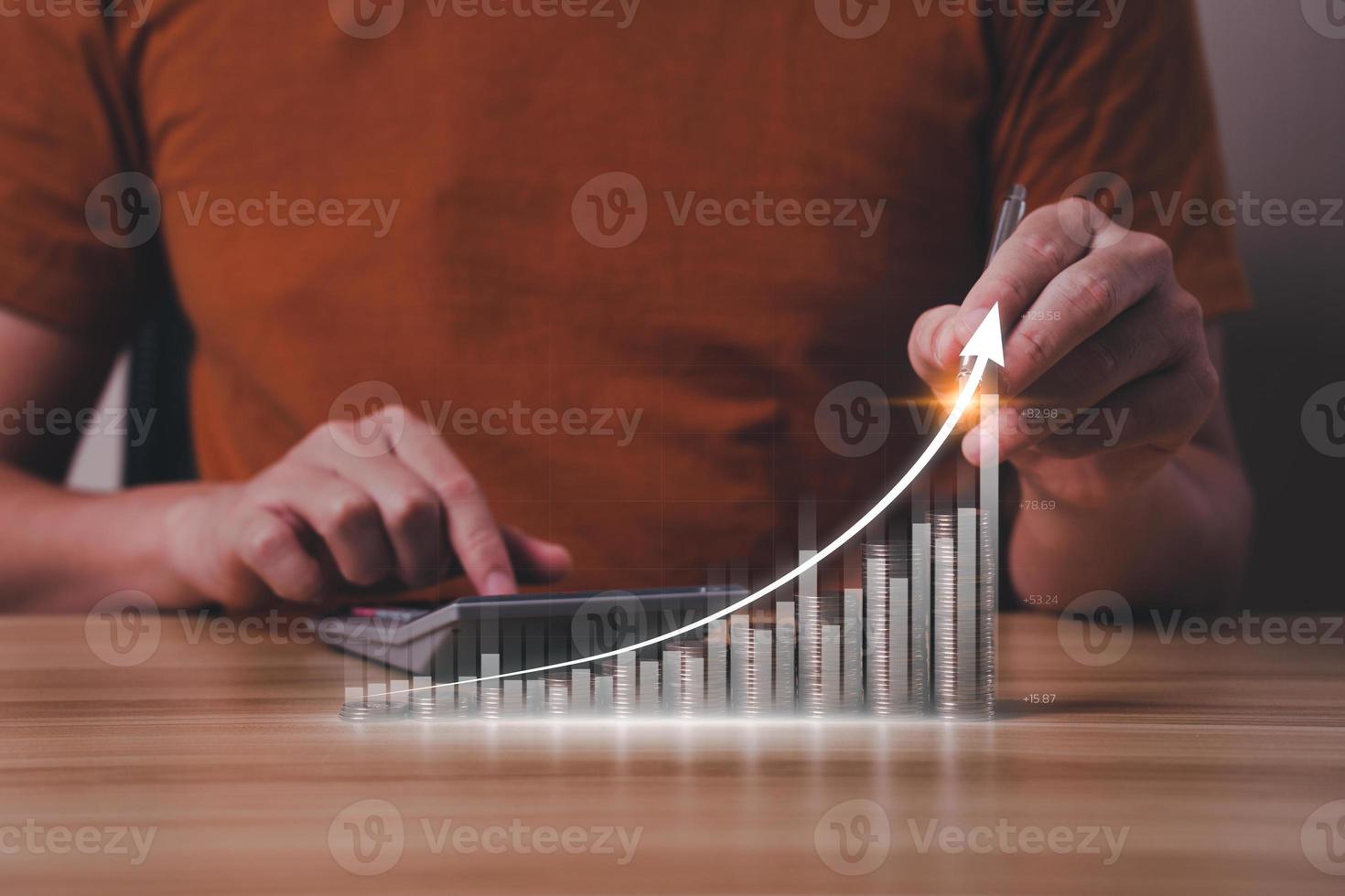 business people planning the growth of financial investments with a calculator along with a graph showing the profit of the business. collecting money, financial planning, save money for the future photo