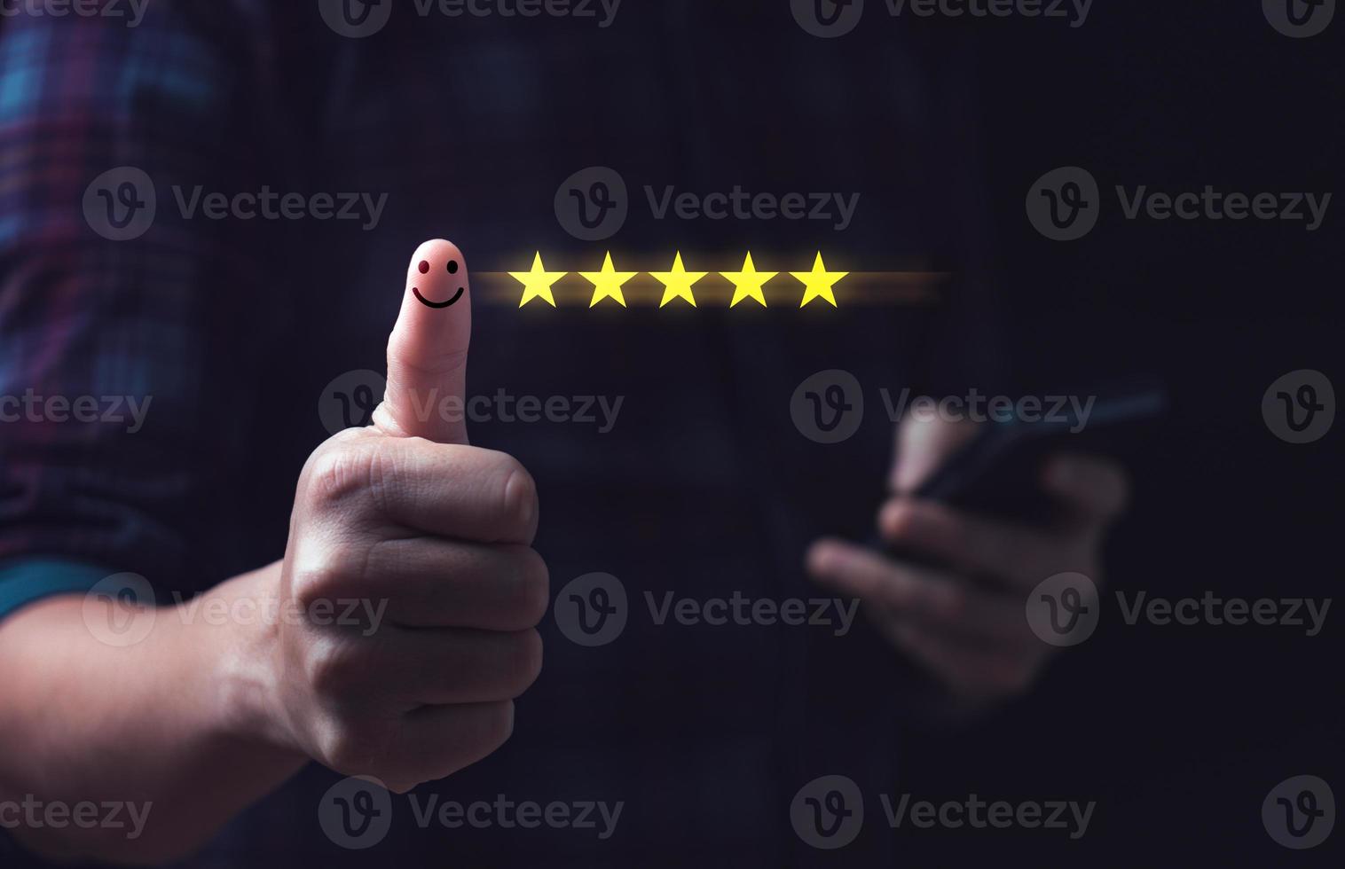 Customer satisfaction concept. Hand with thumb up Positive emotion smiley face icon and five star with copy space. 5 star satisfaction, Excellent business rating experience photo
