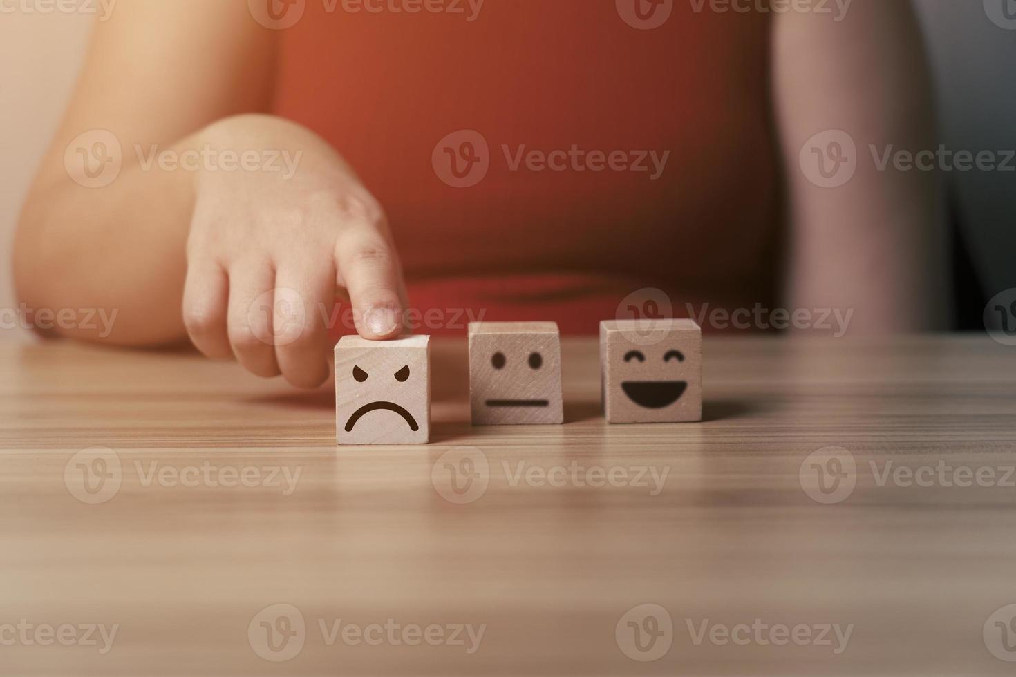 Business women select bad face emoticon on virtual touch screen at smartphone. Bad review, bad service dislike bad quality, low rating, social media not good photo