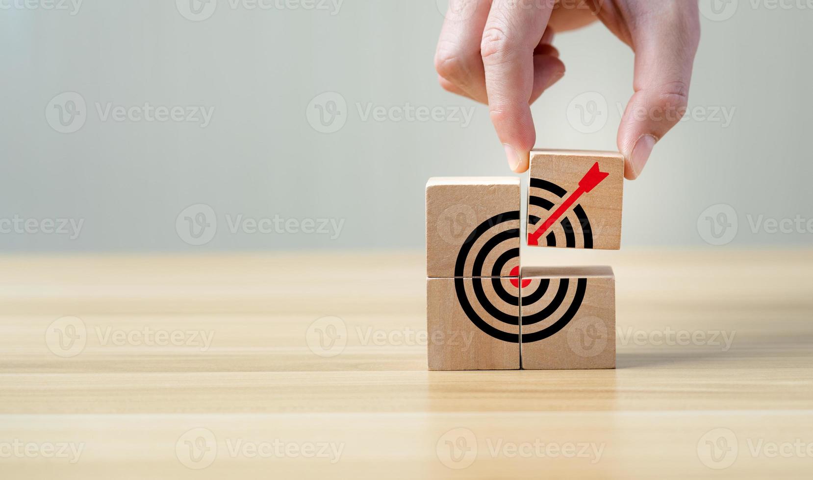 Business achievement goal and objective target concept. Hand man arranging wooden cube block. Business goal and success concept. Focus on a goal and achieve successful business. Copy space. photo