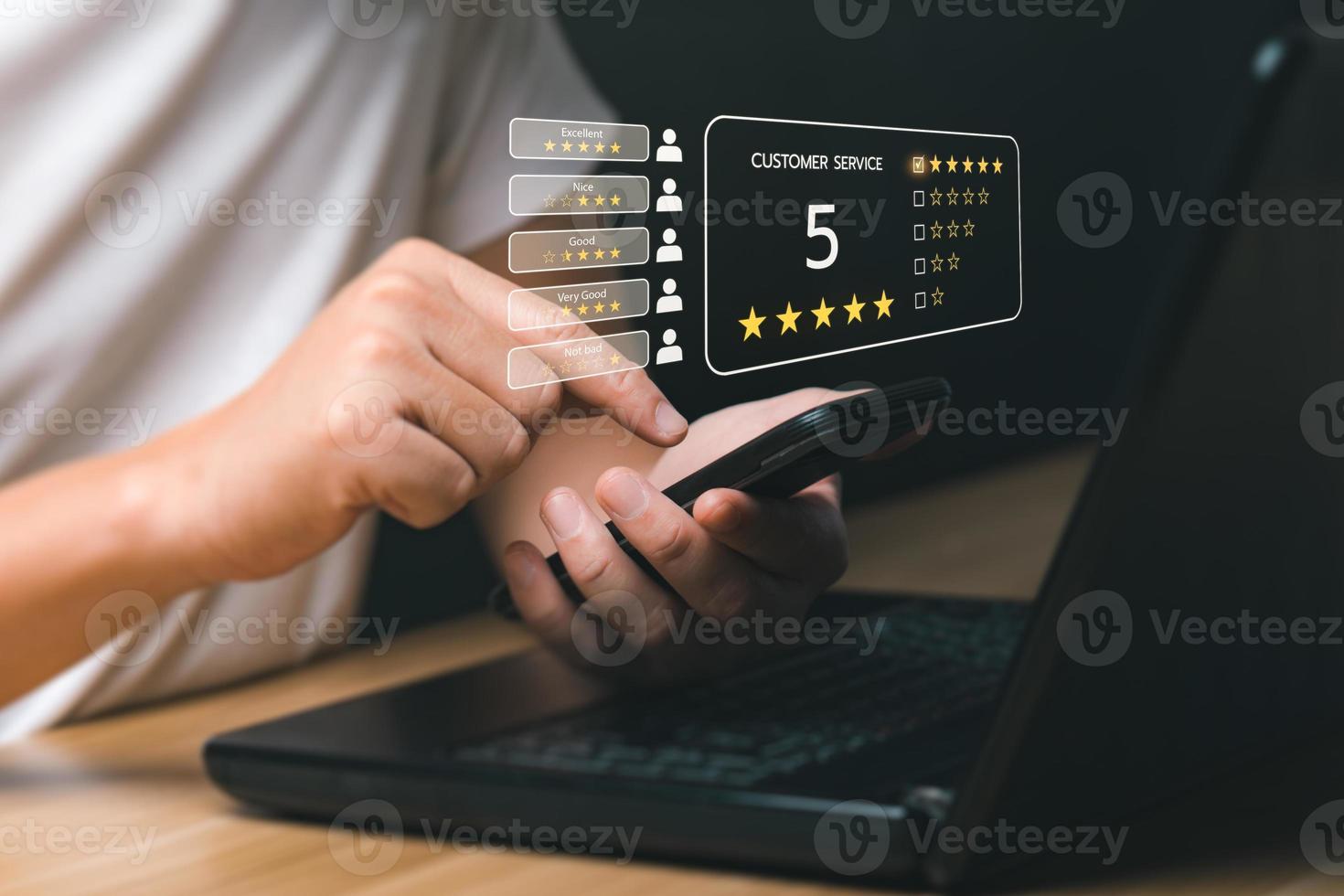 Customer satisfaction concept. Hands of a business man using a smartphone to comment 5 stars. with copy space. 5 star satisfaction, Excellent business rating experience photo