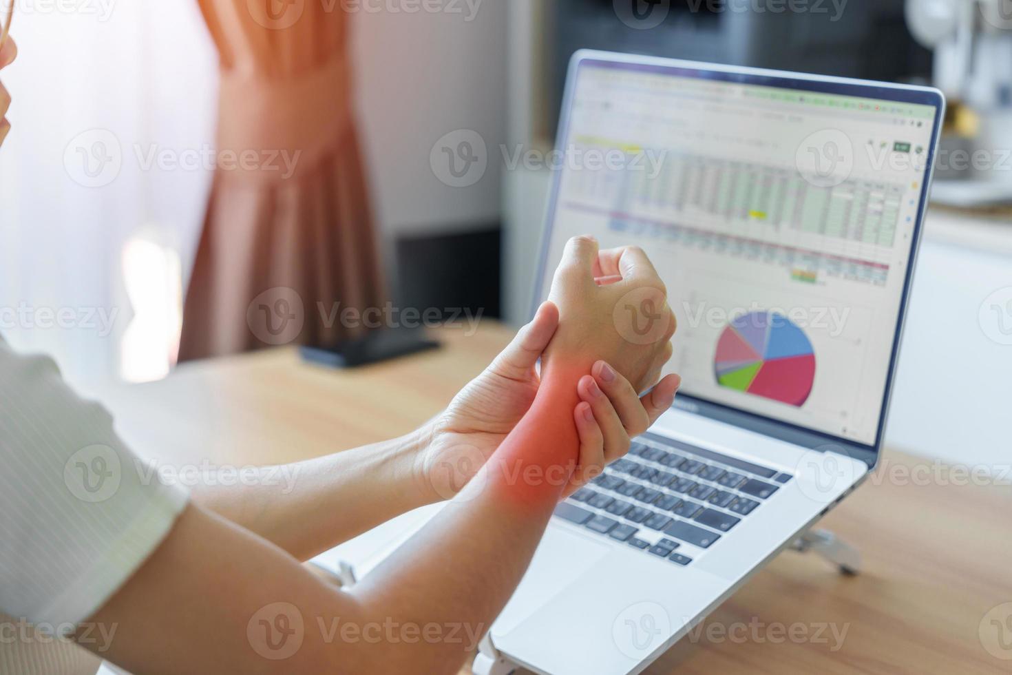 Woman having wrist pain when using laptop computer and mouse during working long time on workplace. De Quervain s tenosynovitis, rheumatism ergonomic, Carpal Tunnel Syndrome or Office syndrome concept photo