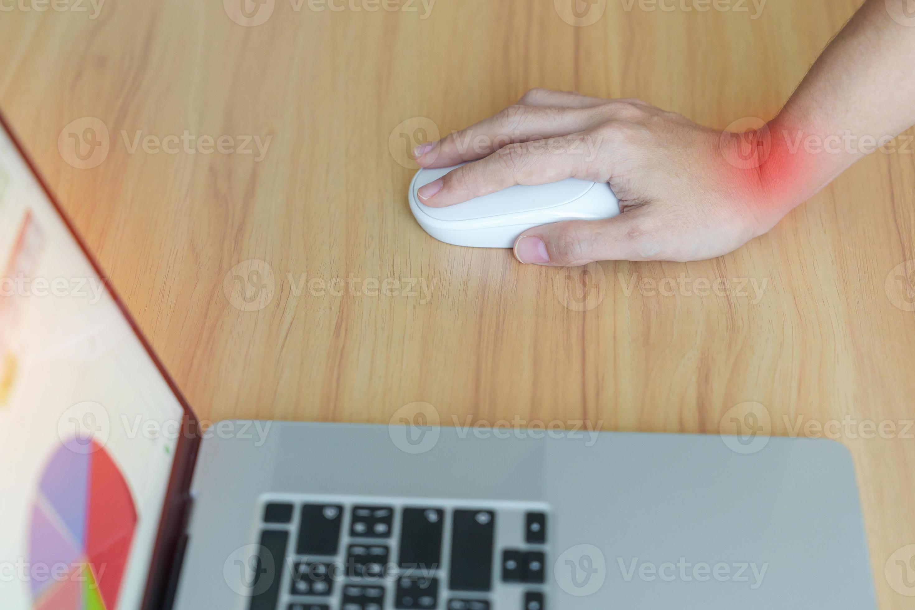 Woman having wrist pain when using mouse during working long time on workplace. De Quervain s