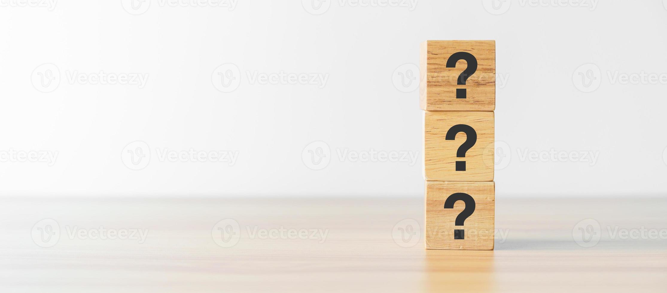 Questions Mark word with wood block on table background. FAQ, frequency asked questions, Answer, Q and A, Information, Communication, questionnaire and Brainstorming Concepts photo