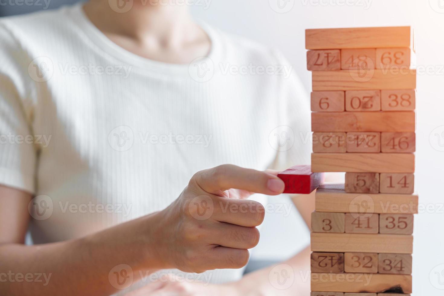 hand placing or pulling wooden block on the tower. Business planning, Decision, Risk Management, Solution and strategy Conceptual photo