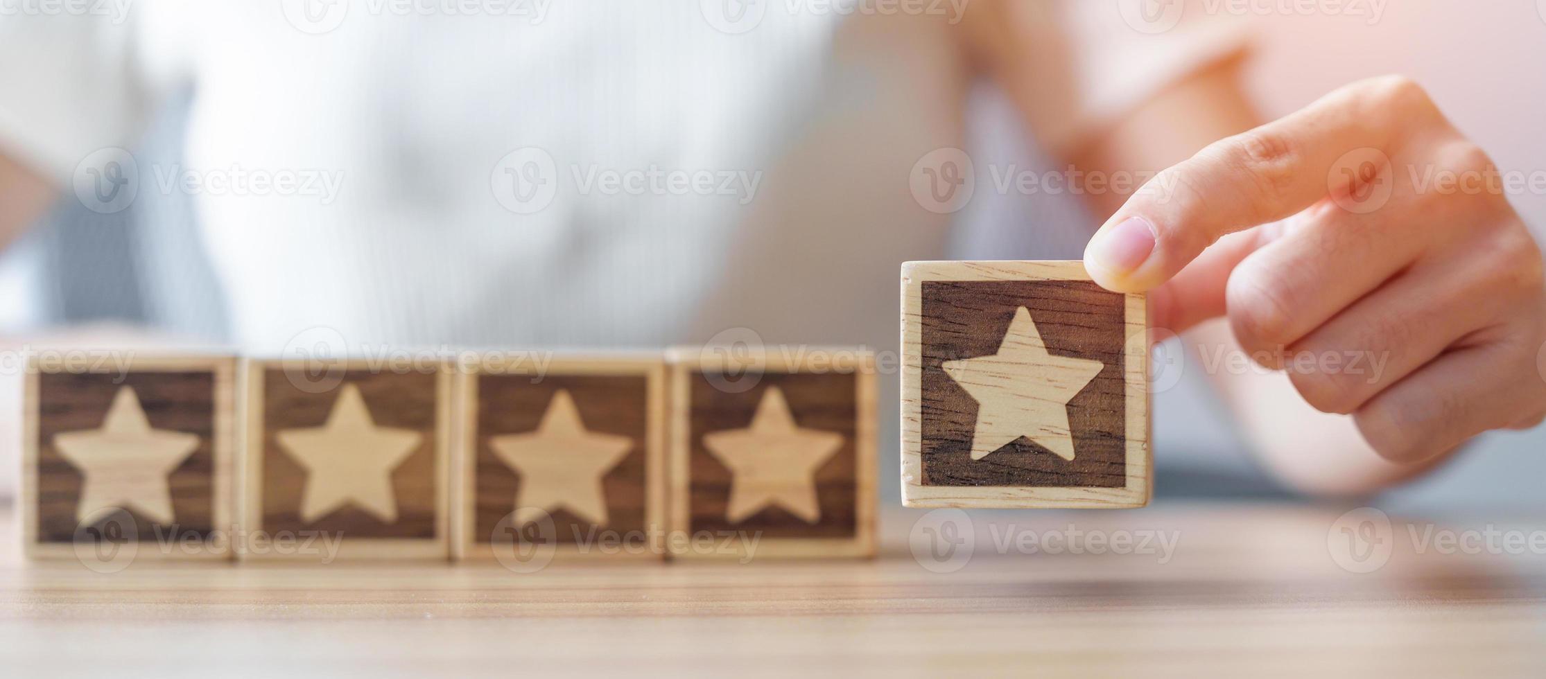 hand holding Star block. Customer choose rating for user reviews. Quality, Service rating, ranking, customer review, satisfaction, evaluation and feedback concept photo