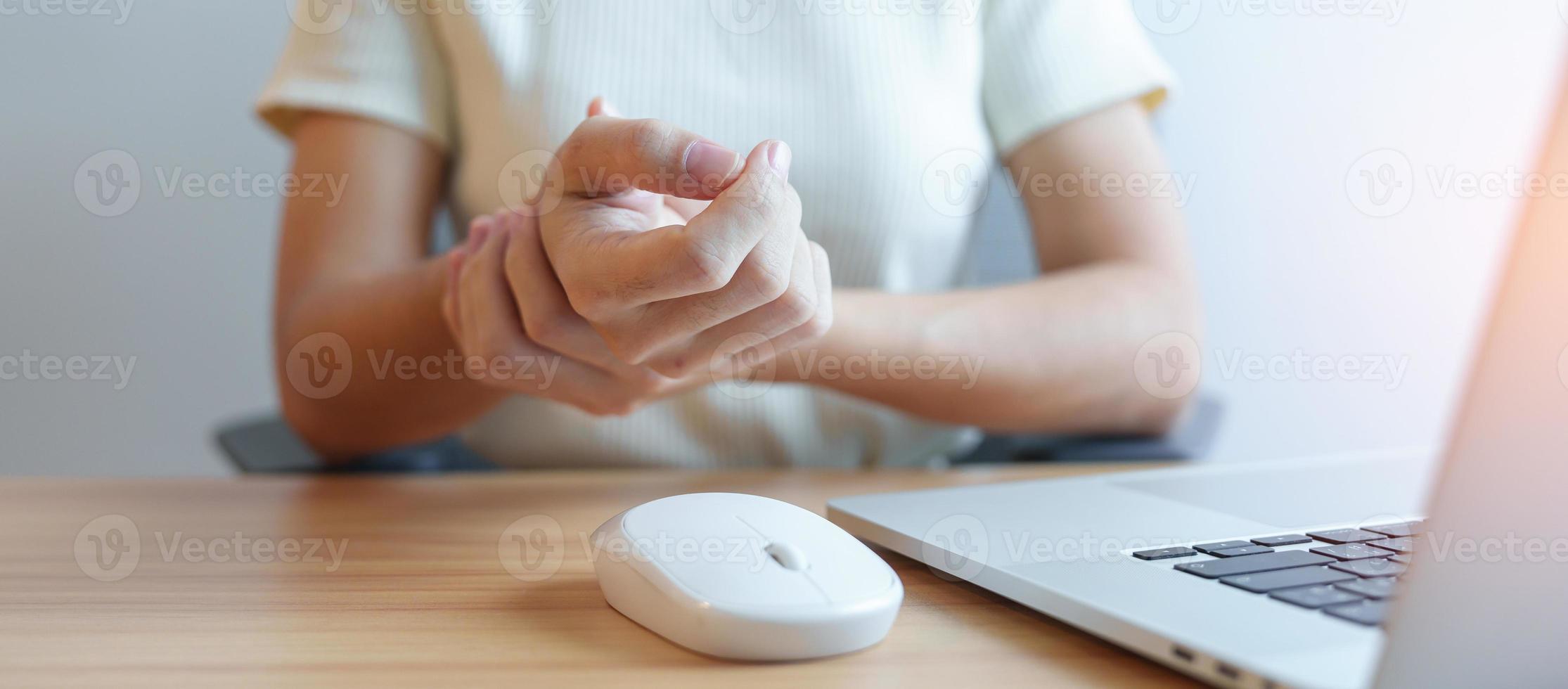 Woman having wrist pain when using mouse during working long time on workplace. De Quervain s tenosynovitis, ergonomic, Carpal Tunnel Syndrome or Office syndrome concept photo