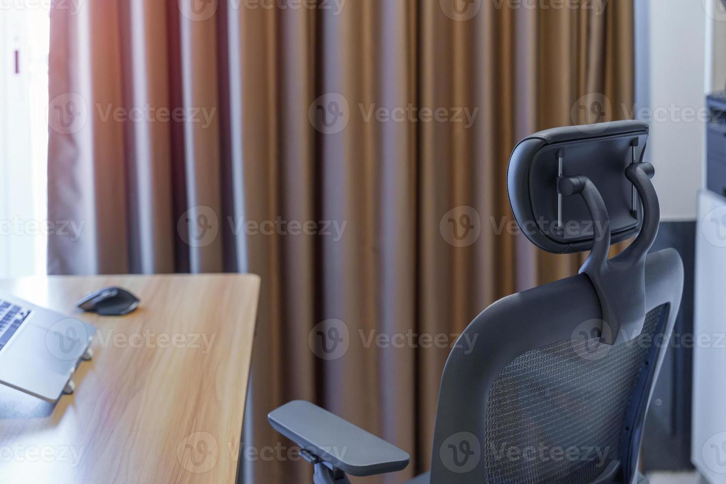 Ergonomic chair and Adjustable table with laptop computer in modern workplace. Good posture to avoid Office syndrome, Back Pain, shoulder ache, fibromyalgia and Neck pain photo
