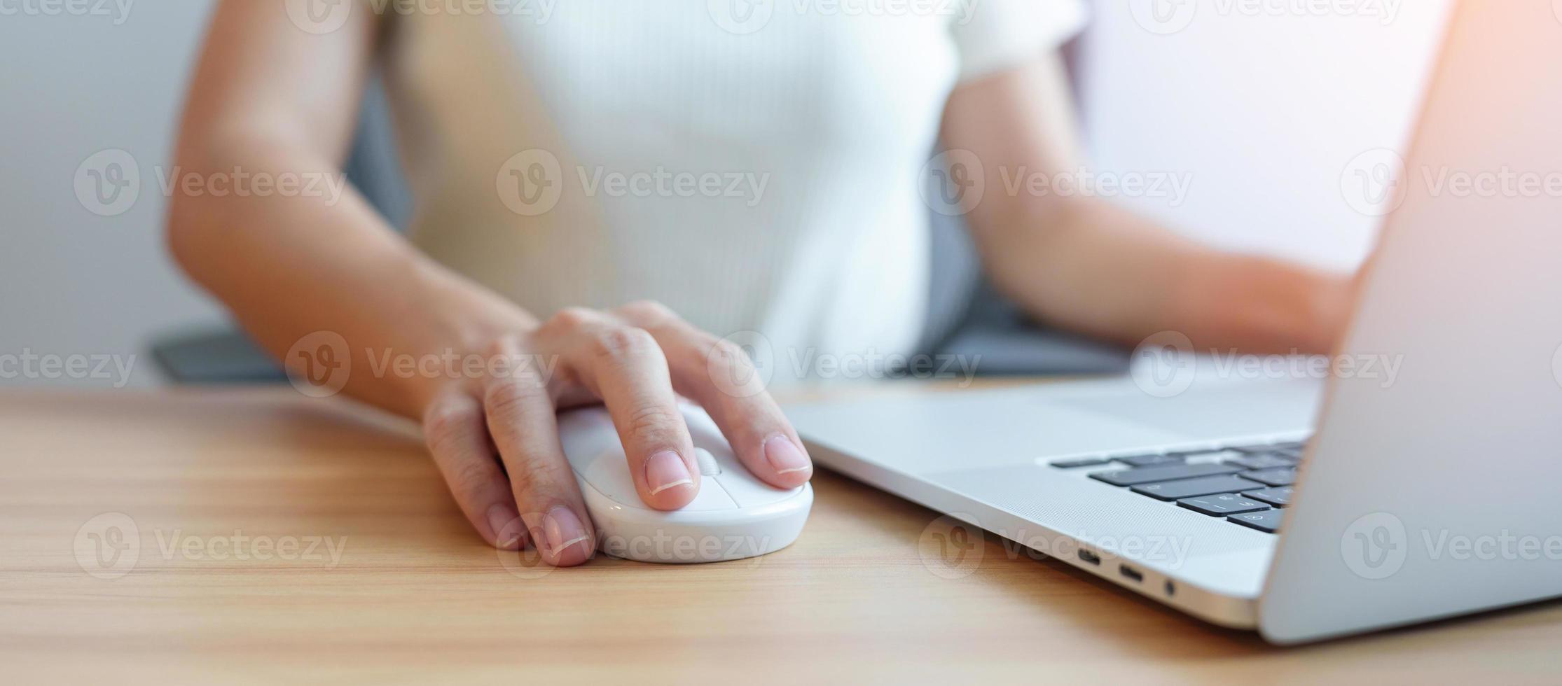 Woman using mouse and laptop computer during working long time on workplace. Wrist pain, De Quervain s tenosynovitis, Ergonomic, Carpal Tunnel Syndrome or Office syndrome concept photo
