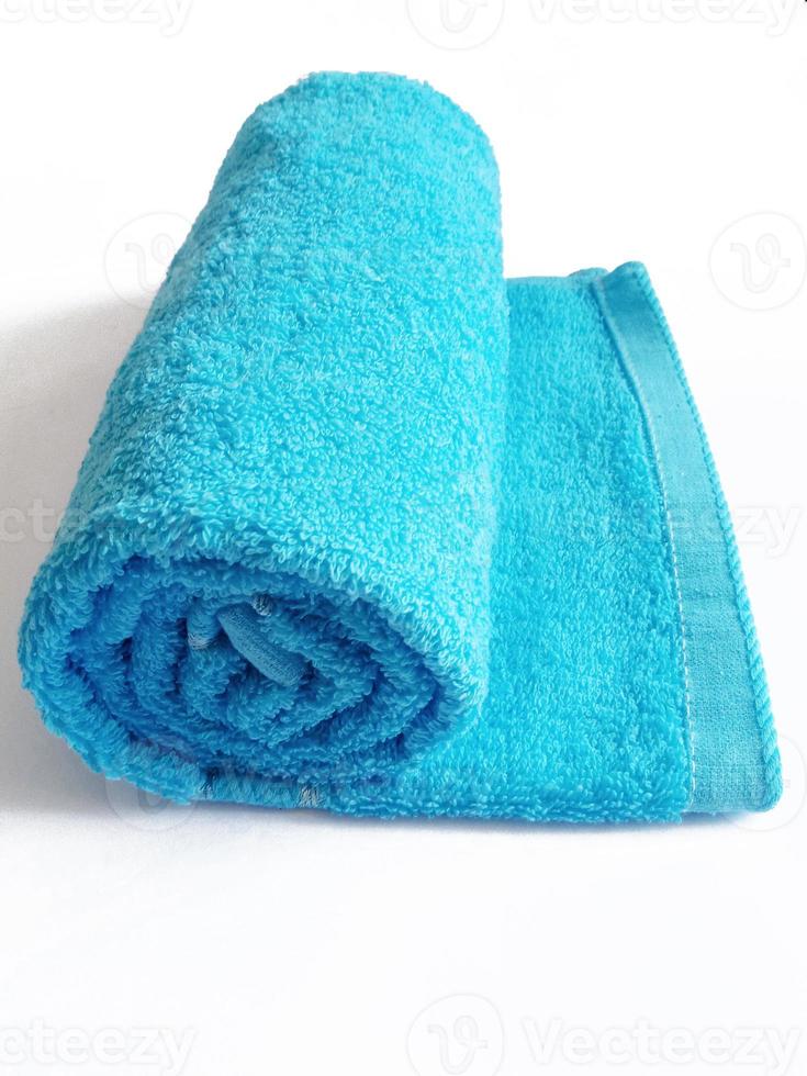 blue bath rolled towel on white background photo