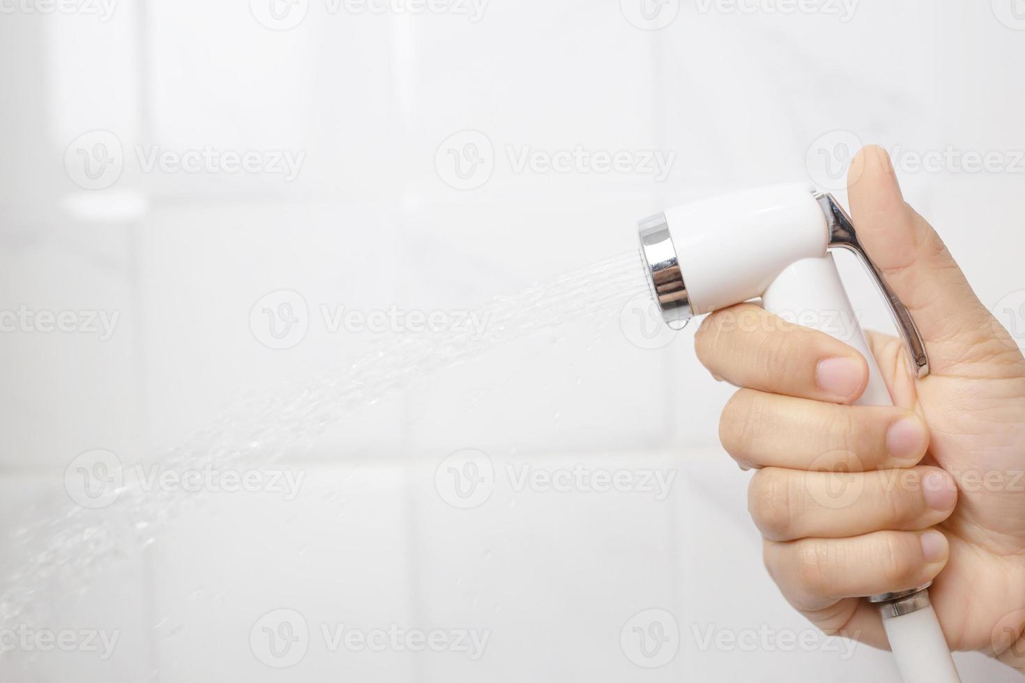 A man using a bidet in the bathroom photo