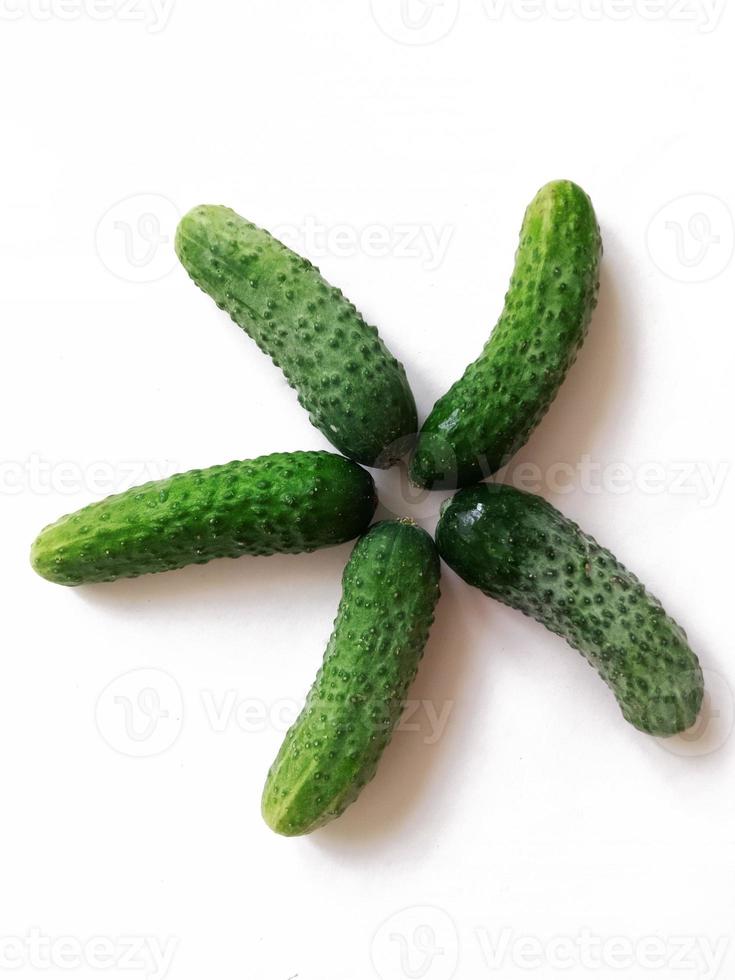 fresh cucumbers arranged in star shape isolated on white background photo
