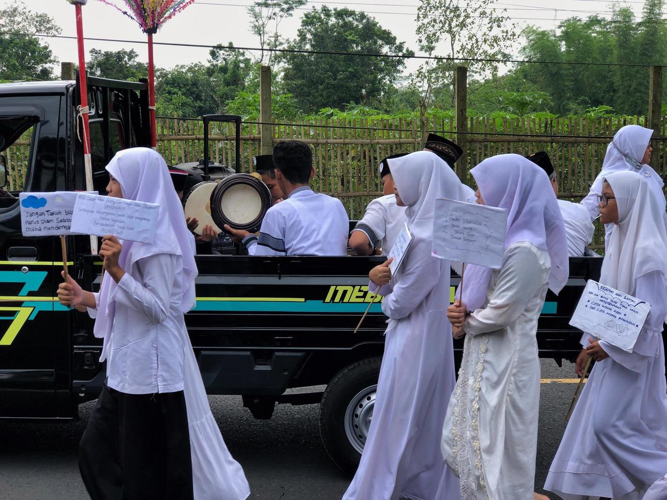 BLITAR, INDONESIA - October 21, 2022 Junior high school students from MTSN 5 Blitar are in a parade to commemorate Santri Day and the Birthday of the Prophet Muhammad photo