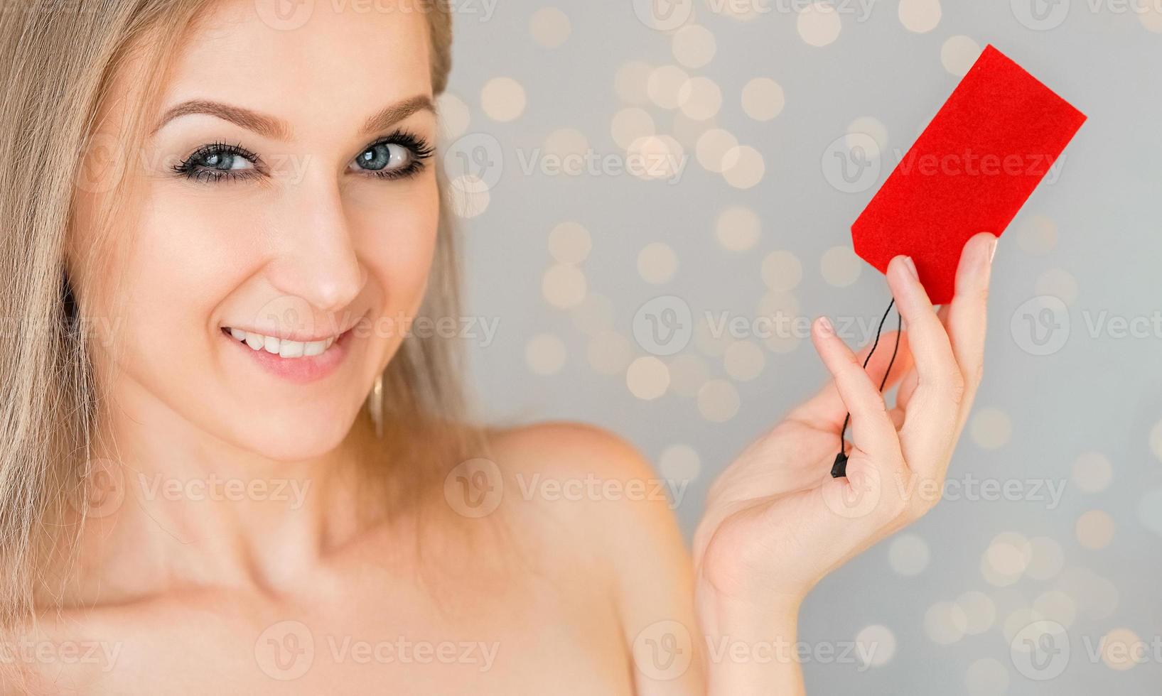 Woman holds price tag photo