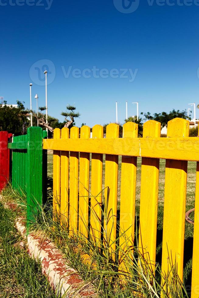 Colorful wooden fence of a playground. Vertical image. photo