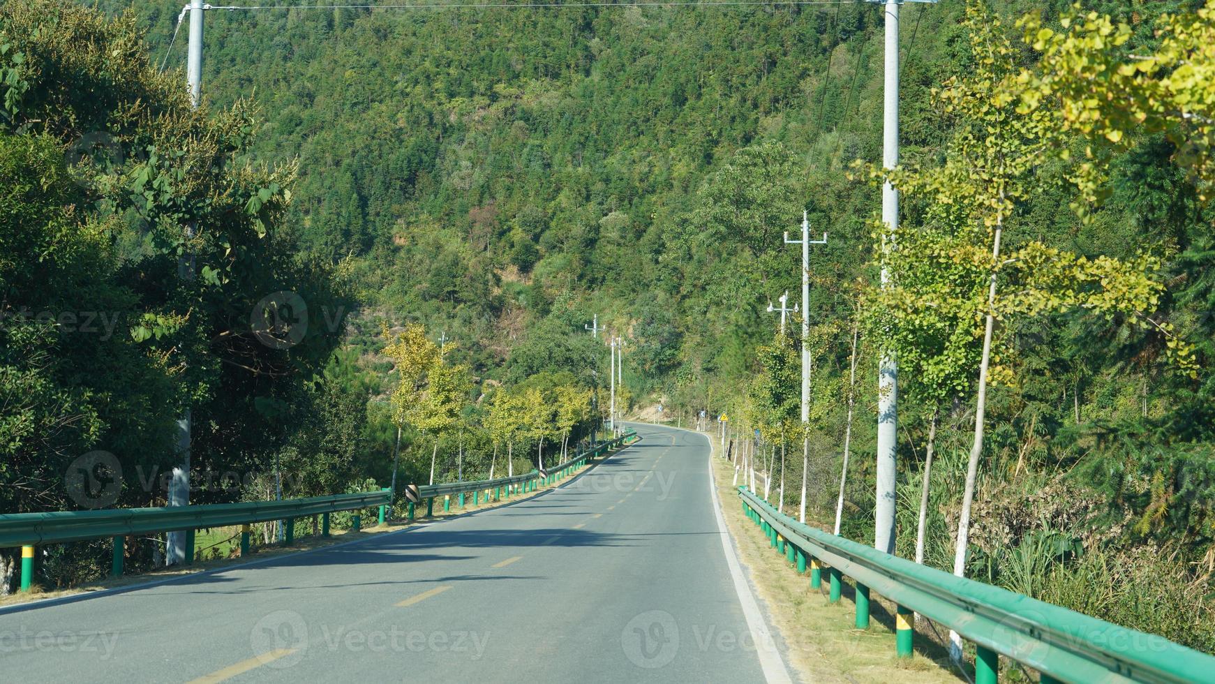 The beautiful countryside view with the road and mountains as background photo