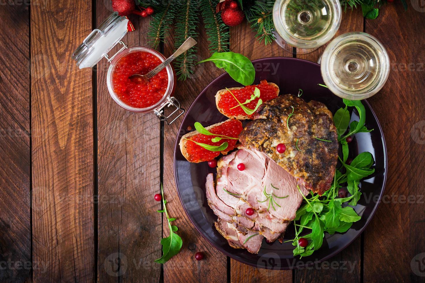 Christmas baked ham and red caviar, served on the old wooden table. Flat lay. Top view photo