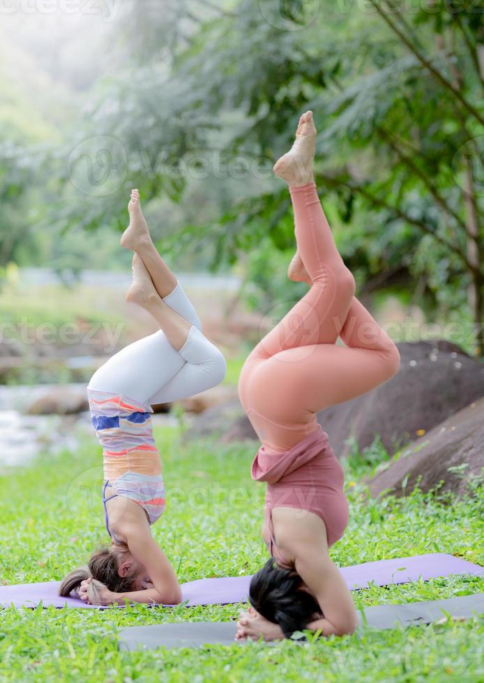 Young woman yoga outdoors on the lawn. photo