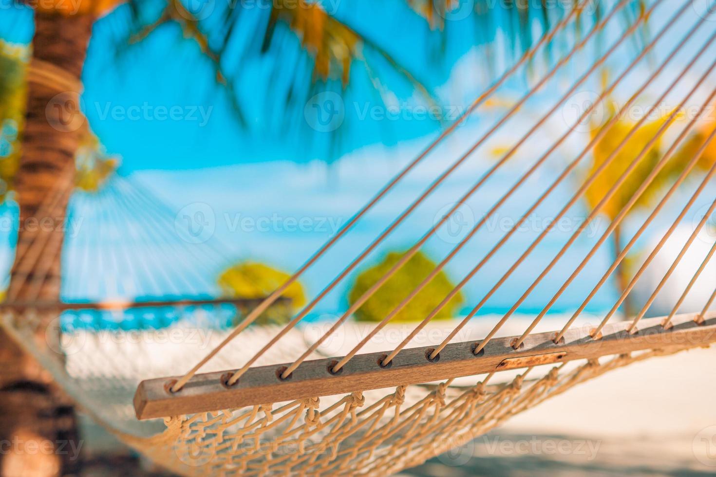 Relaxing hammock on a palm tree and sunset glare near sea ocean. Tropical nature pattern, travel background. Inspirational freedom carefree template, beach sunset. Paradise island concept photo