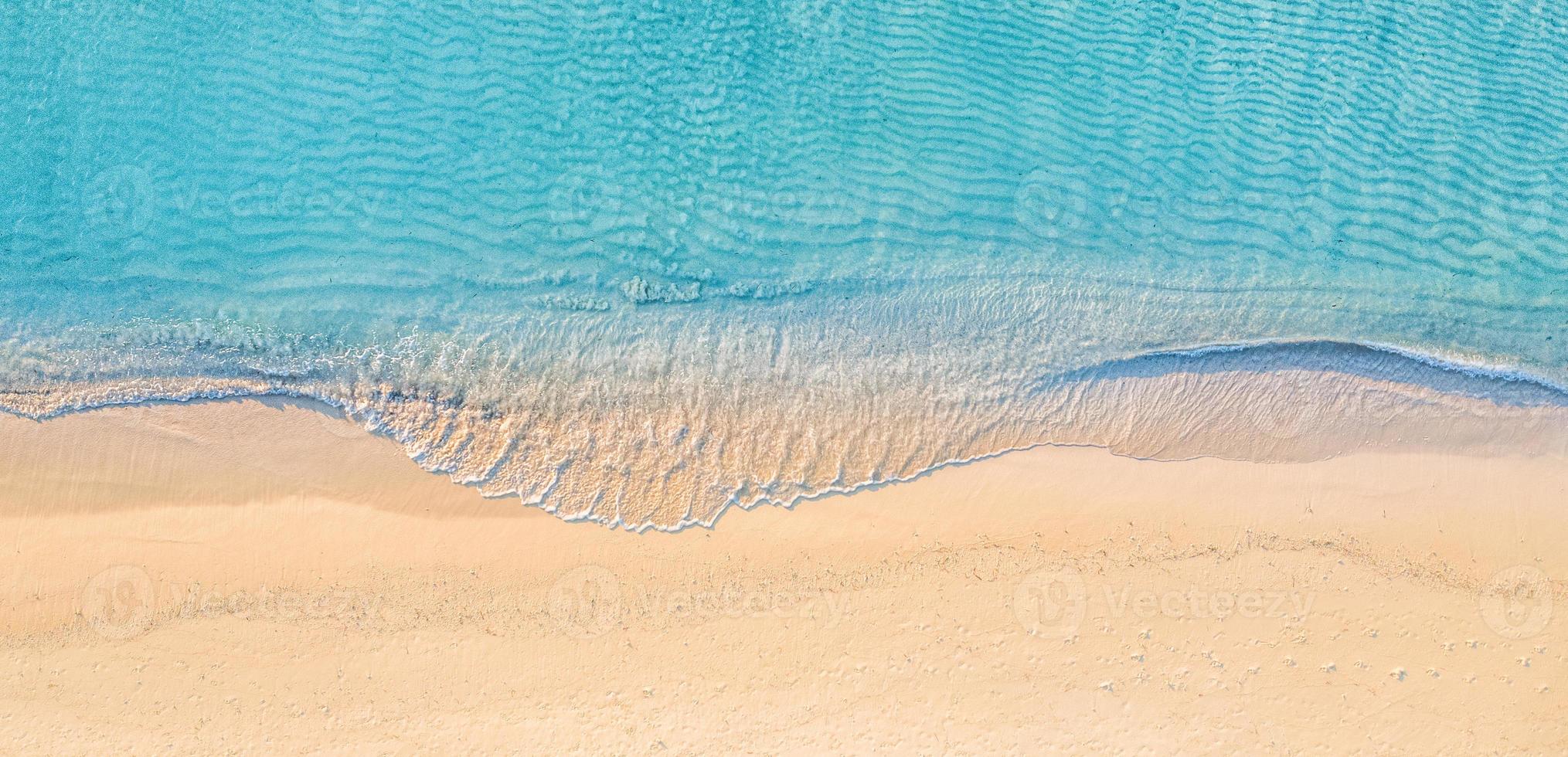 Relaxing aerial beach scene, summer vacation holiday template banner. Waves surf with amazing blue ocean lagoon, sea shore, coastline. Perfect aerial drone top view. Peaceful bright beach, seaside photo