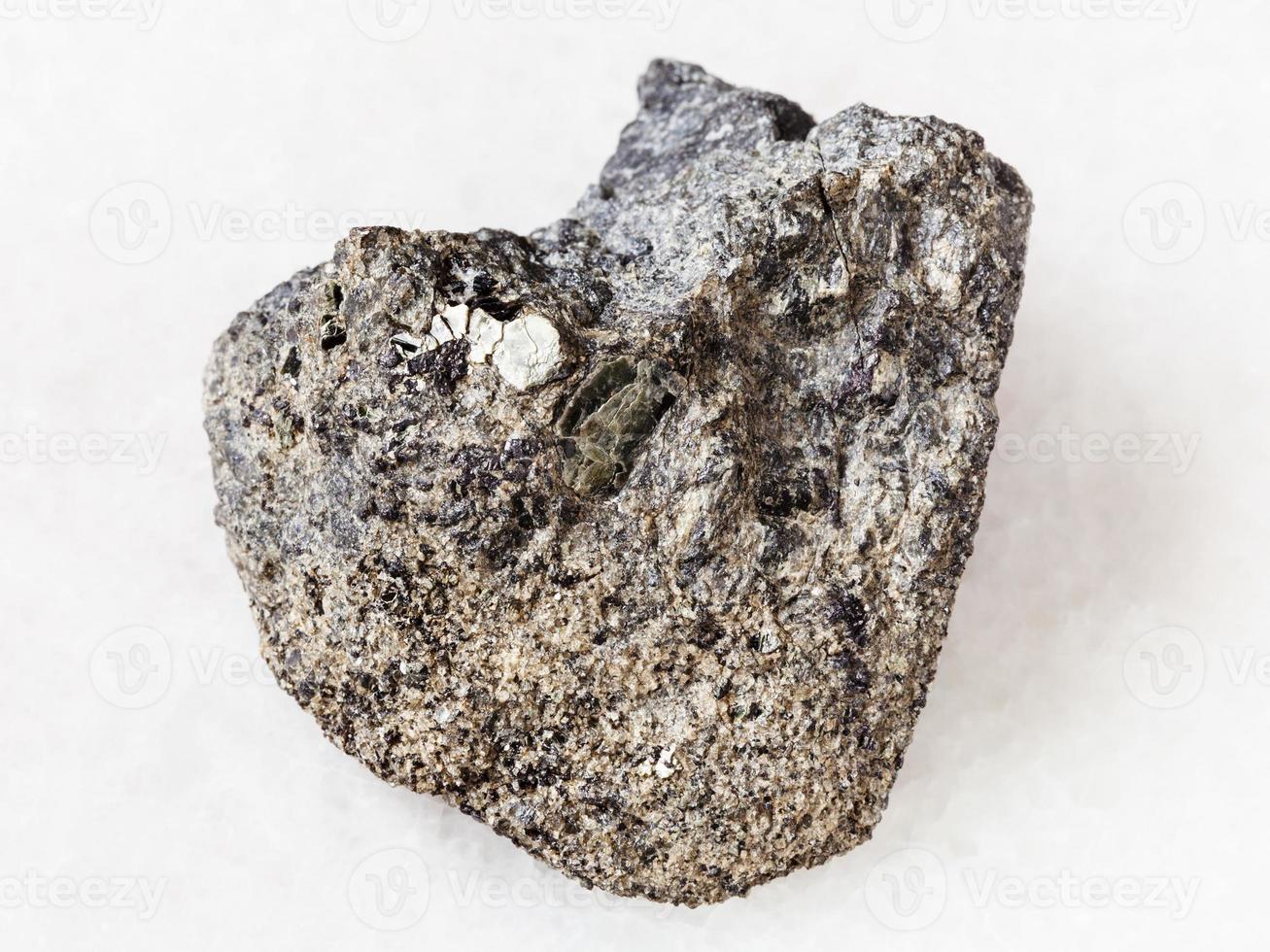 raw peridotite stone with phlogopite mica on white photo