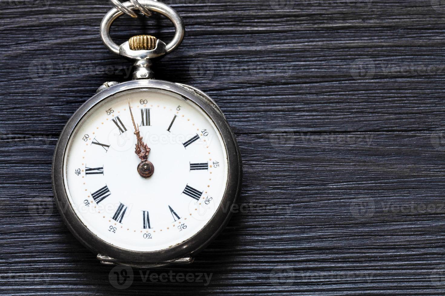 dos minutos para las doce en reloj antiguo en negro foto