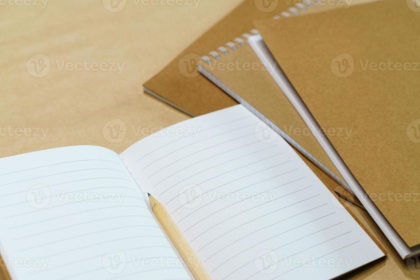 Blank white notepad and pencil on paper background. Mock up, top view, copy photo