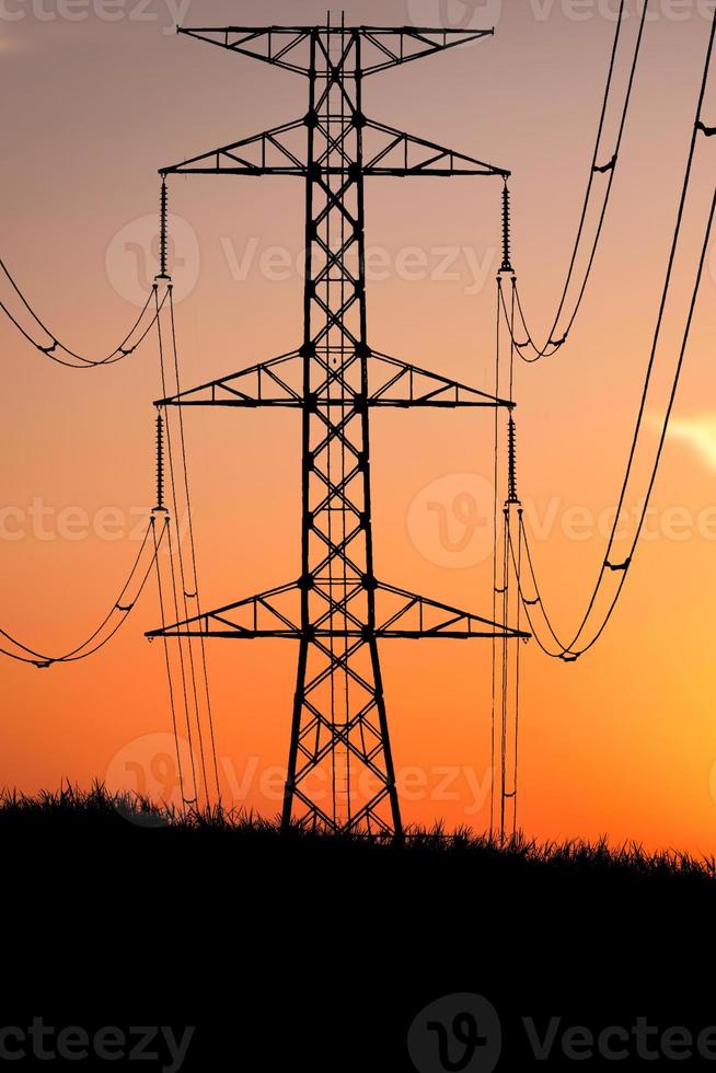 Silhouettes of high voltage poles and power lines It has a complex steel structure, it is strong and durable. photo