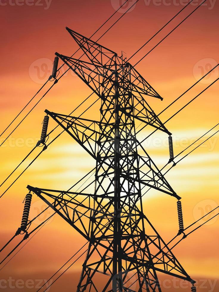 Silhouettes of high voltage poles and power lines It has a complex steel structure, it is strong and durable. photo