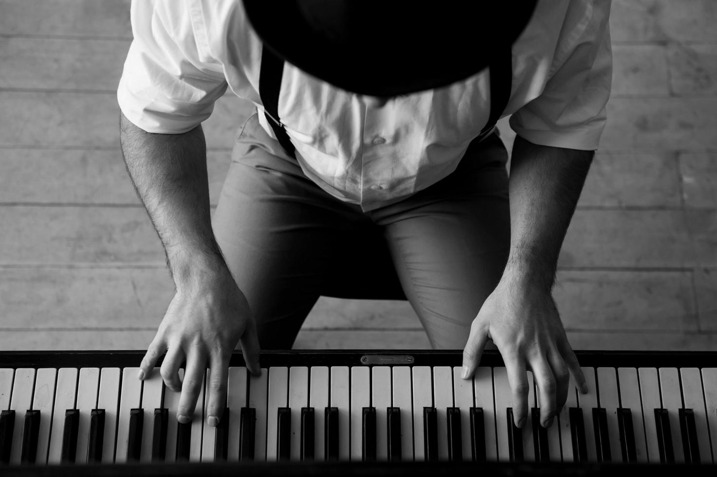 Talent and virtuosity. Black and white top view image of man playing piano photo