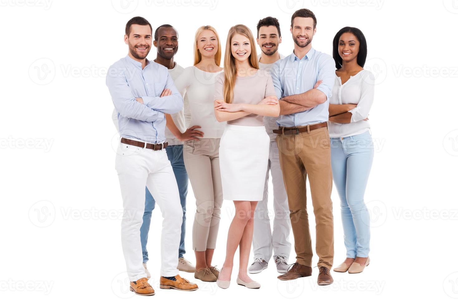 Proud to be a team. Full length of multi-ethnic group of people in smart casual wear looking at camera and smiling while standing against white background photo