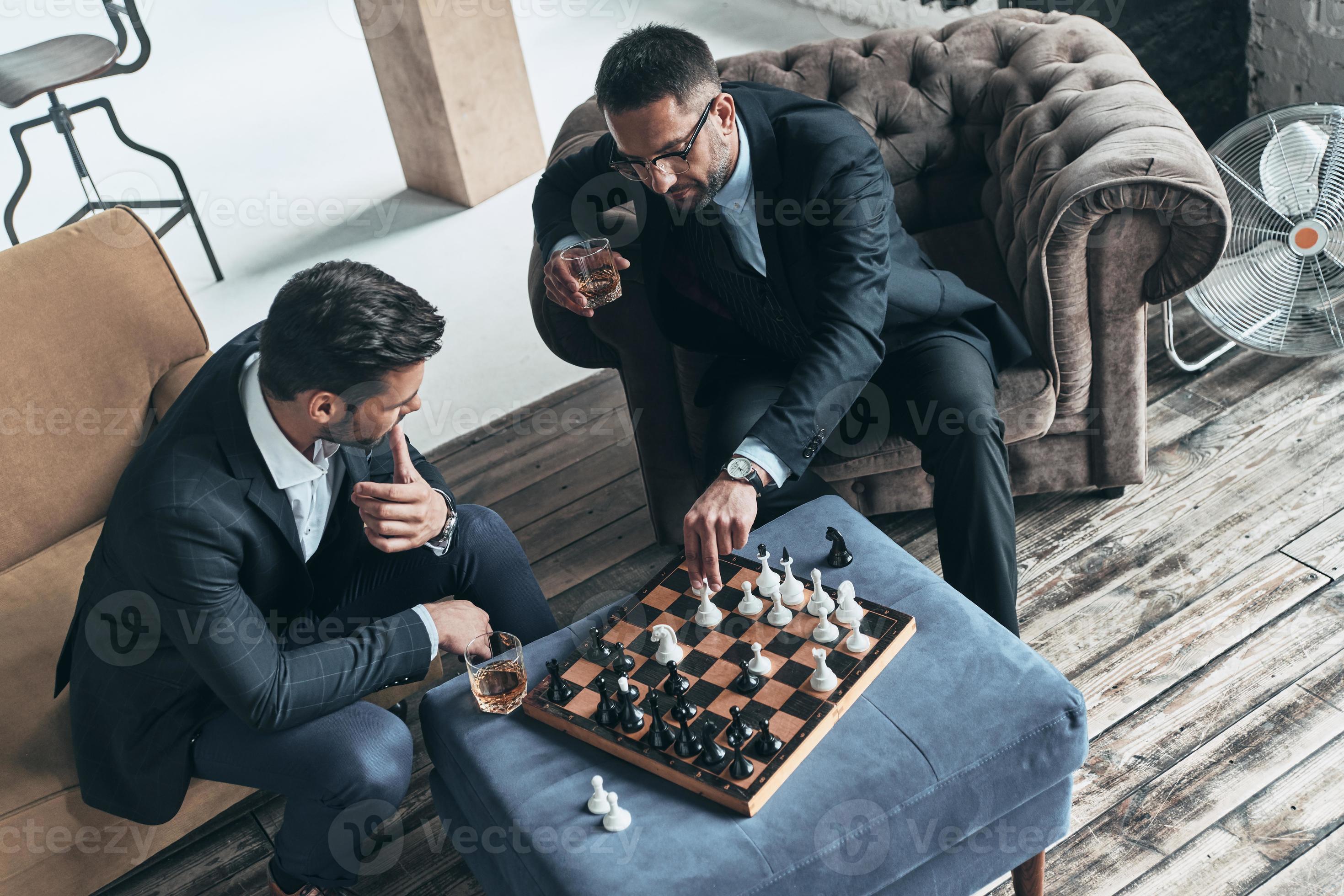 Free Photo  Men playing chess indoors side view