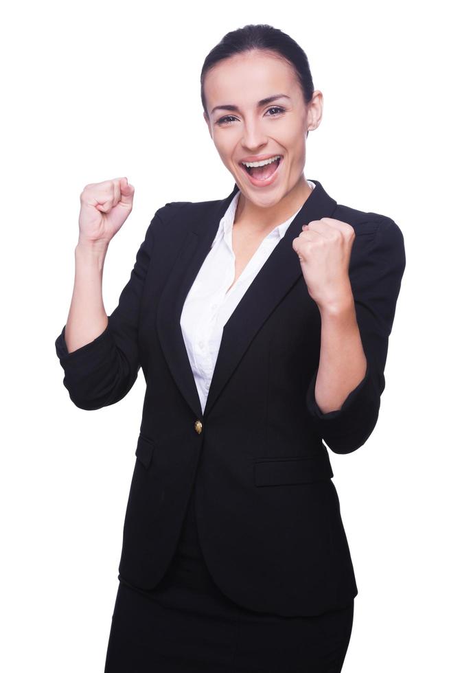 Successful businesswoman. Happy young woman in formalwear gesturing and smiling while standing isolated on white photo